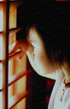 Girl looking through shutter